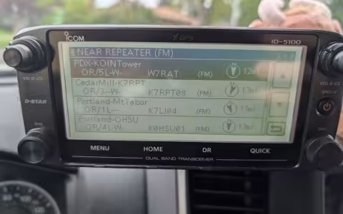 An ICOM-5100 as mounted in a Dodge Ram, displaying the screen and the nearby repeater search functionality.